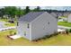 Rear view of a two story house with gray siding and a small patio at 12000 Conrad Cir, Hampton, GA 30228