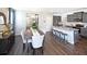 Open dining room features hardwood floors and view of kitchen at 12000 Conrad Cir, Hampton, GA 30228