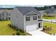Two-story house with gray siding, black windows, and a two-car garage at 12000 Conrad Cir, Hampton, GA 30228