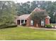 Brick home with front porch and landscaped yard at 1652 Taylor Oaks Rdg, Lawrenceville, GA 30043