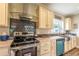 Modern kitchen with stainless steel range and glass hood at 1107 N Van Wert Rd, Villa Rica, GA 30180