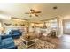Open living room featuring a spacious layout, blue sofas, and a large ceiling fan at 1107 N Van Wert Rd, Villa Rica, GA 30180
