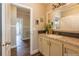 View of a light-filled bathroom with a vanity, sink, and access to another room at 1107 N Van Wert Rd, Villa Rica, GA 30180