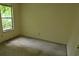 Small bedroom with window and stained carpet at 2900 Kevin Ln, Jonesboro, GA 30236