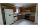 Small kitchen needing updates with wood cabinets and appliances at 2900 Kevin Ln, Jonesboro, GA 30236