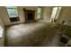 Large living room with brick fireplace and stained carpet at 2900 Kevin Ln, Jonesboro, GA 30236