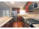 Modern kitchen with granite counters, stainless steel appliances, and hardwood floors at 1715 Moores Mill Rd, Atlanta, GA 30318