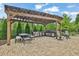 Outdoor kitchen and dining area with pergola, providing a great entertaining space at 3830 Teesdale Ct, Sandy Springs, GA 30350