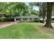 Charming brick ranch home nestled amongst lush greenery, offering a serene setting at 705 Inglewood Se Dr, Smyrna, GA 30080