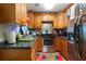 Cozy kitchen with wood cabinets, stainless steel appliances, and a colorful rug at 705 Inglewood Se Dr, Smyrna, GA 30080