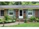 Brick home with gray shutters, well-maintained landscaping, and a welcoming entrance at 705 Inglewood Se Dr, Smyrna, GA 30080
