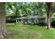 Brick ranch home with gray shutters, well-maintained lawn, and mature trees at 705 Inglewood Se Dr, Smyrna, GA 30080