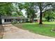 Brick ranch home with gray shutters, well-maintained lawn, and mature trees at 705 Inglewood Se Dr, Smyrna, GA 30080