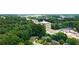 Aerial view showing the neighborhood, highlighting tree coverage and road access at 705 Inglewood Se Dr, Smyrna, GA 30080