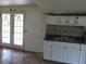 Small kitchen with white cabinets and a tile backsplash at 126 Irvin St, Jonesboro, GA 30236