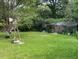 Large backyard with mature trees and a windmill at 126 Irvin St, Jonesboro, GA 30236