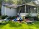 Older home with a screened porch and cluttered yard at 126 Irvin St, Jonesboro, GA 30236