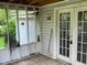 Small screened porch with damaged screen and old broom at 126 Irvin St, Jonesboro, GA 30236