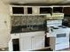 Small kitchen with outdated appliances and cabinets at 126 Irvin St, Jonesboro, GA 30236