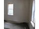 Small bedroom with carpet and two windows, ready for renovation at 126 Irvin St, Jonesboro, GA 30236