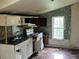 Small kitchen with outdated appliances and cabinets at 126 Irvin St, Jonesboro, GA 30236