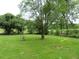 Large backyard with mature trees and a windmill at 126 Irvin St, Jonesboro, GA 30236