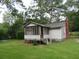 Older home with a screened porch and large trees at 126 Irvin St, Jonesboro, GA 30236