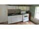 Small kitchen with white cabinets and a tile backsplash at 126 Irvin St, Jonesboro, GA 30236
