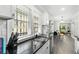 Modern kitchen with white cabinets, black countertops, and stainless steel appliances at 976 Washington St, Atlanta, GA 30315