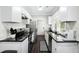 Modern kitchen with white cabinets, black countertops, and stainless steel appliances at 976 Washington St, Atlanta, GA 30315