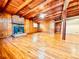 Living room featuring hardwood floors, wood paneling, and a brick fireplace at 504 N Little Victoria Rd, Woodstock, GA 30189