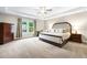 Spacious main bedroom featuring a large bed, ample natural light and a ceiling fan at 138 Stargaze Rdg, Canton, GA 30114