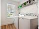 Bright laundry room features washer, dryer, and built-in shelving at 1587 Alder Se Ct, Atlanta, GA 30317