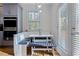 Bright eat-in kitchen nook with white bench seating and window at 1587 Alder Se Ct, Atlanta, GA 30317