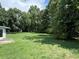 Spacious backyard with lush green grass and trees at 1799 Brandy Woods Se Trl, Conyers, GA 30013