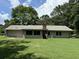Back of house with a large yard and mature trees at 1799 Brandy Woods Se Trl, Conyers, GA 30013