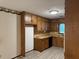 Galley-style kitchen with wood cabinets and linoleum flooring at 1799 Brandy Woods Se Trl, Conyers, GA 30013