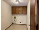 Laundry area with upper cabinets and space for washer and dryer at 1799 Brandy Woods Se Trl, Conyers, GA 30013