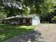 Ranch style home with a carport and mature landscaping at 1799 Brandy Woods Se Trl, Conyers, GA 30013
