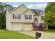 Two-story house with attached garage and landscaped yard at 376 Cattlemans Cir, Mcdonough, GA 30252