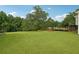 Large backyard with grassy area, deck and trees at 376 Cattlemans Cir, Mcdonough, GA 30252