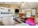 Open living room with hardwood floors and a view into the kitchen at 376 Cattlemans Cir, Mcdonough, GA 30252