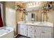 Double vanity bathroom with white cabinets and a large mirror at 376 Cattlemans Cir, Mcdonough, GA 30252