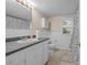 Clean bathroom with single sink vanity and shower/tub combo at 6860 Main St, Lithonia, GA 30058
