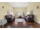 Spacious living room with hardwood floors and comfy sofas at 6860 Main St, Lithonia, GA 30058