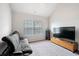Cozy bedroom with a futon, large TV, and carpeted floor at 5410 Whisper Ct, Cumming, GA 30028