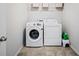 Laundry room with washer, dryer, and overhead shelving at 5410 Whisper Ct, Cumming, GA 30028