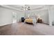 Main bedroom with a large bed and carpeted floor at 5410 Whisper Ct, Cumming, GA 30028
