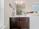 Bathroom with dark brown vanity and a large mirror at 5410 Whisper Ct, Cumming, GA 30028
