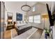 Main bedroom with hardwood floors, large windows, and a stylish chandelier at 330 Heatherden Ave, Fayetteville, GA 30214